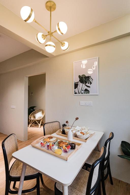 A bright dining area prepared with a plated breakfast spread for four.