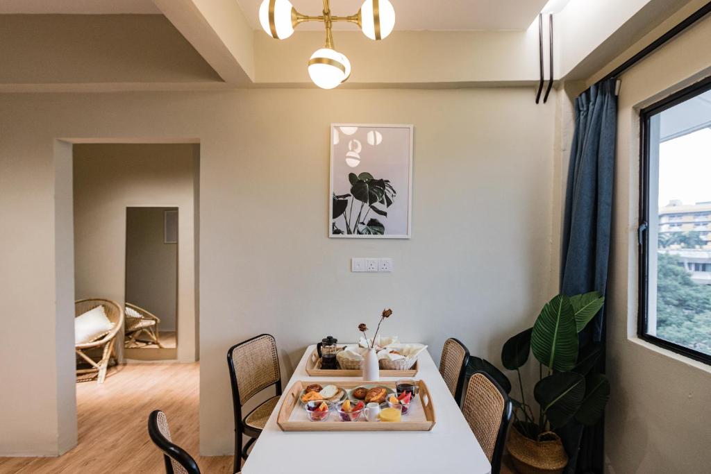 A compact dining area is set for breakfast beside a large window.