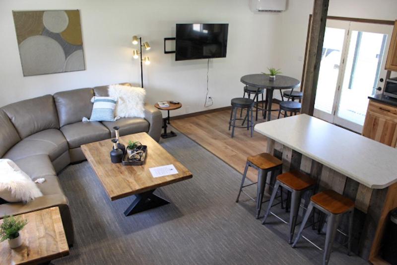 a living room with a couch and a table at Cabin 6 at Horse Creek Resort in Rapid City