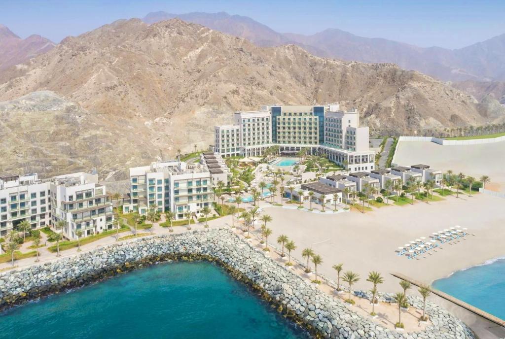 an aerial view of a resort on a beach at Luxurious apartment at address residences in Fujairah