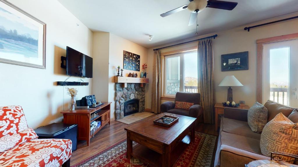 a living room with a couch and a fireplace at Juniper Springs Lodge #539 Condo in Mammoth Lakes