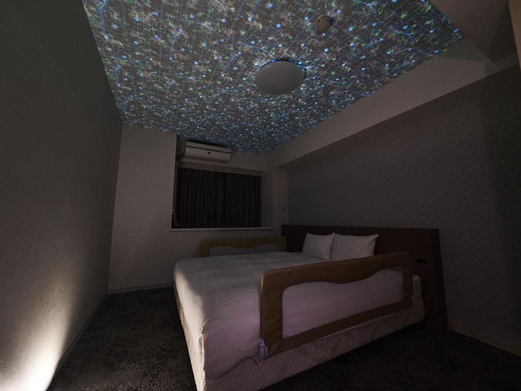 Postel nebo postele na pokoji v ubytování Hotel Village Izukogen