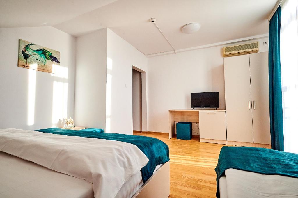 Postel nebo postele na pokoji v ubytování Hotel-Apartments Roxy&Maryo