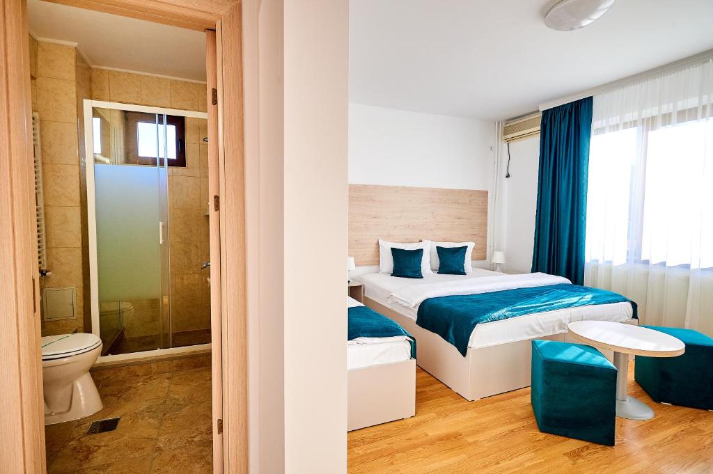 Postel nebo postele na pokoji v ubytování Hotel-Apartments Roxy&Maryo
