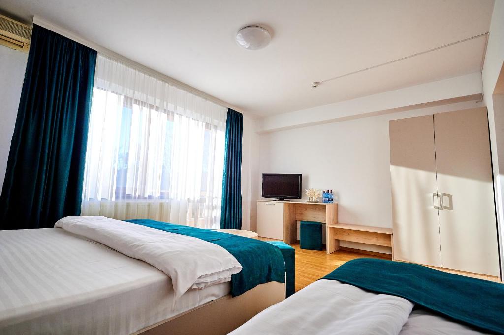 Postel nebo postele na pokoji v ubytování Hotel-Apartments Roxy&Maryo