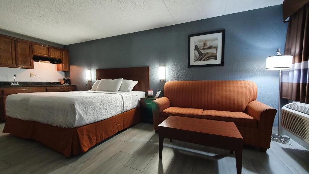 una camera d'albergo con letto e sedia di South Padre Island Inn a South Padre Island