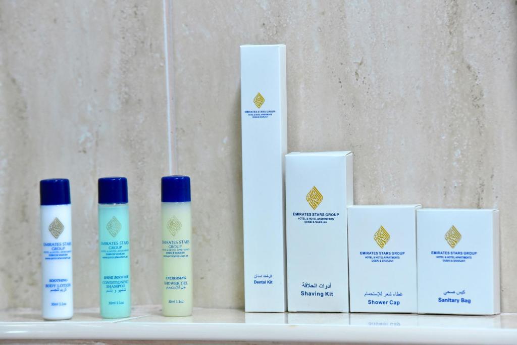 four bottles of sunscreen sitting on a shelf at Emirates Stars Hotel Apartments Dubai in Dubai
