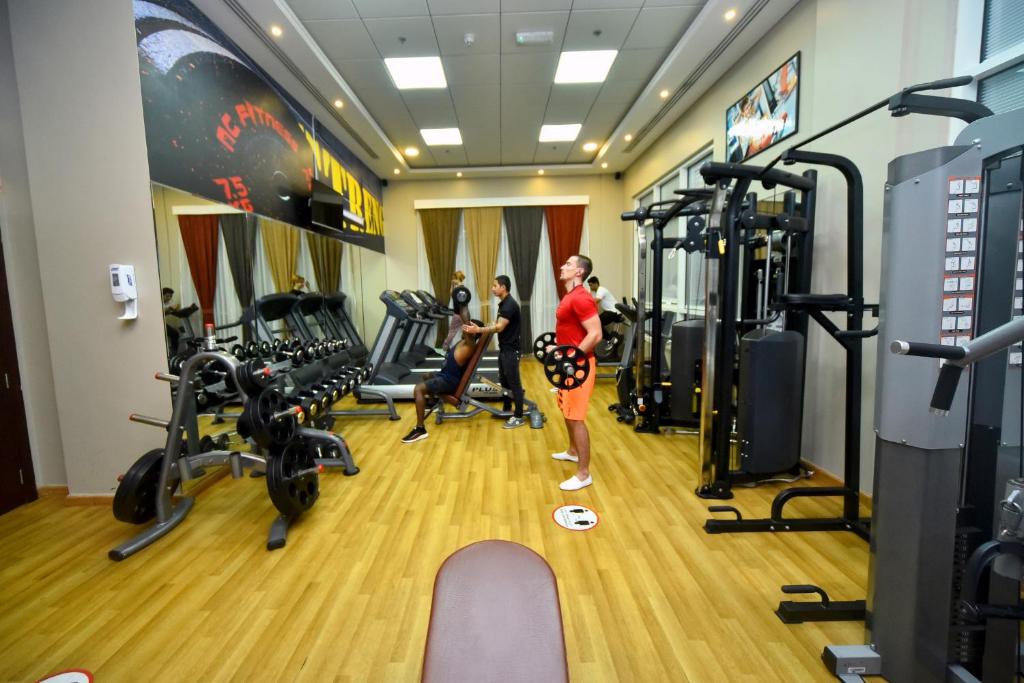 a man and a boy in a gym at Emirates Stars Hotel Apartments Dubai in Dubai