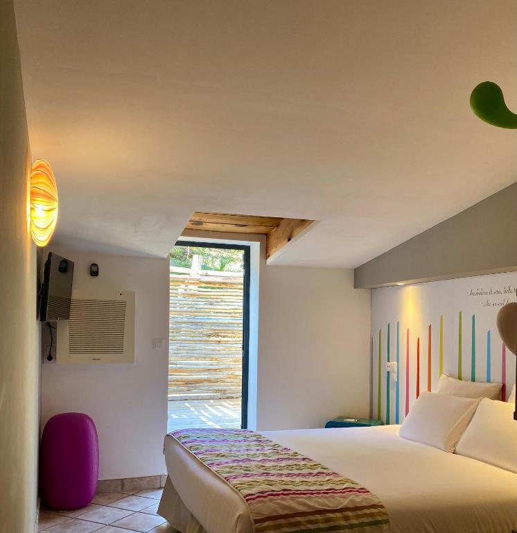 Postel nebo postele na pokoji v ubytování Hôtel Domaine A Flatta