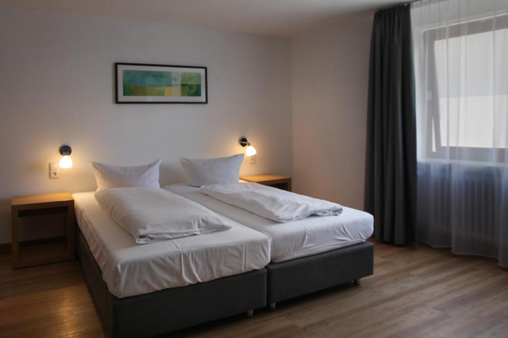 Postel nebo postele na pokoji v ubytování Hotel Gasthof Metzgerei Lamm - Benedikt Rückel