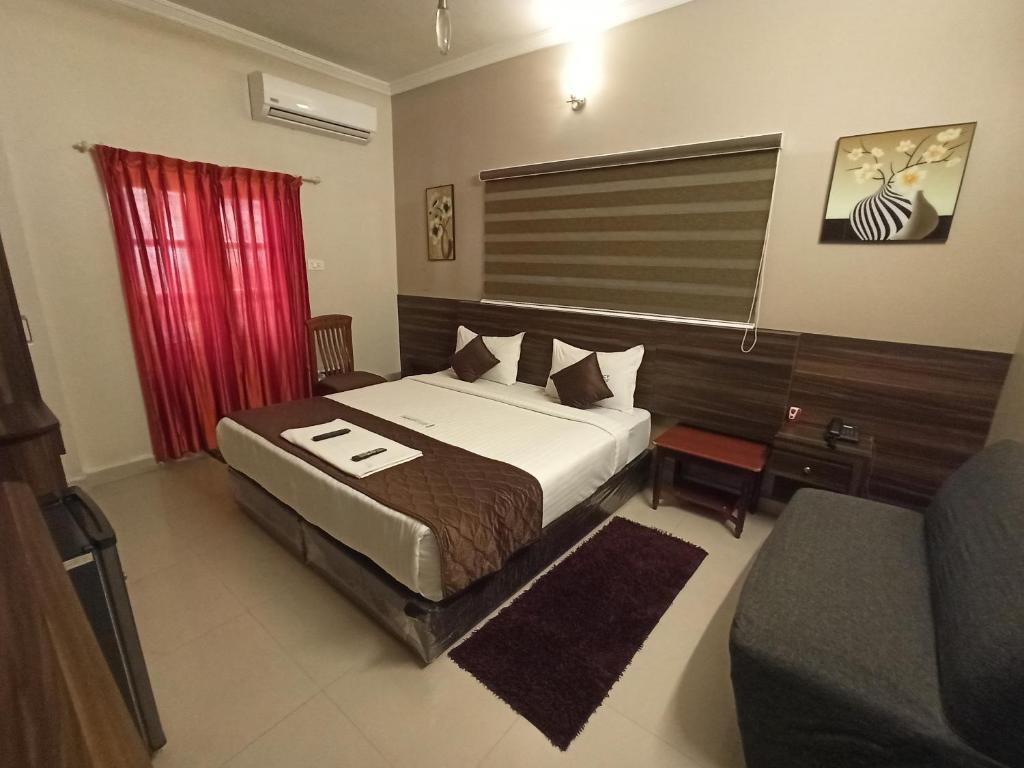 Hotel I-Way Residency Perungudi tesisinde bir odada yatak veya yataklar