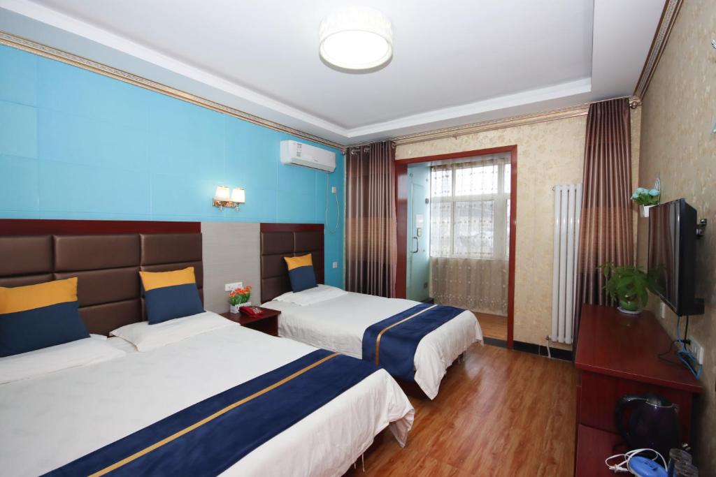 Postel nebo postele na pokoji v ubytování One Meter Sunshine Xi'an Xianyang International Airport Hotel