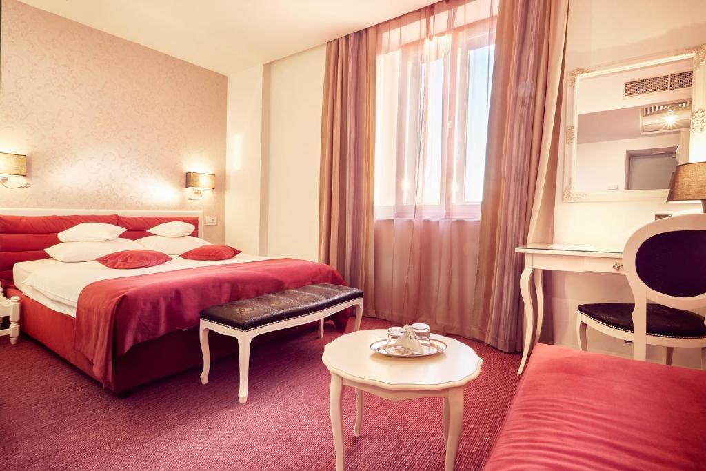 a hotel room with two beds and a window at Continental Forum Sibiu in Sibiu