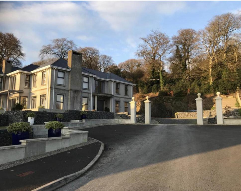 a house with a driveway in front of it at Luxurious Studio Apartment in Fahan Co Donegal in Fahan