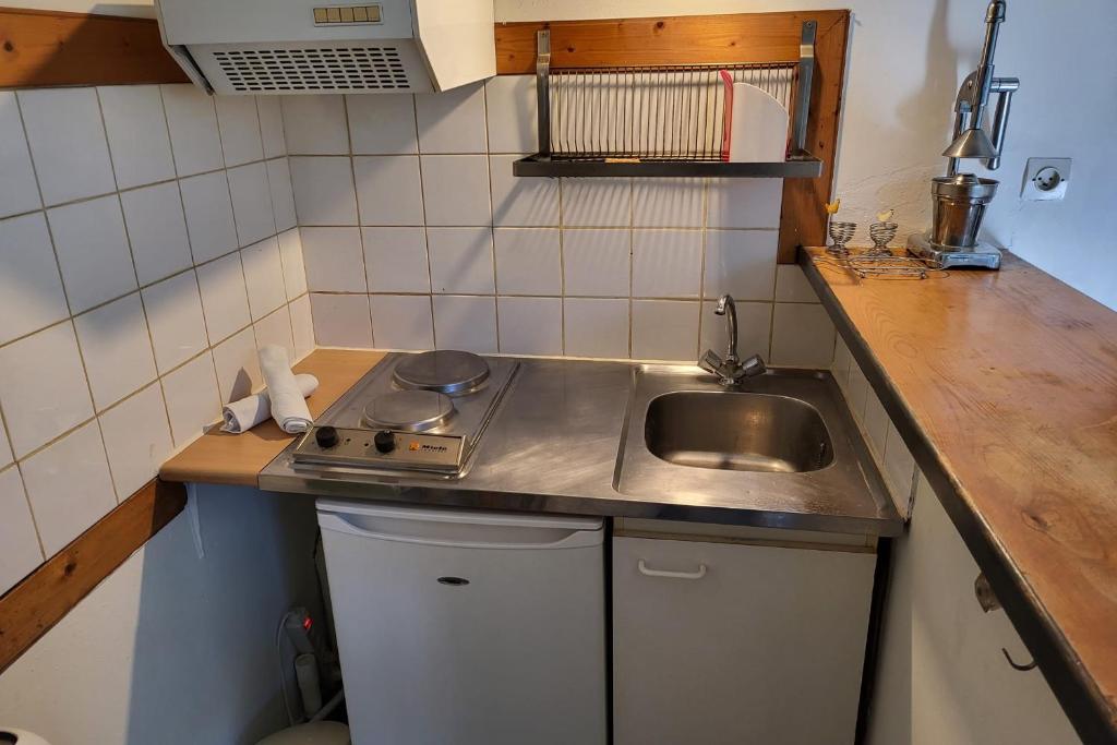 a small kitchen with a sink and a counter top at STUDIO of 24m with small patio in Avignon