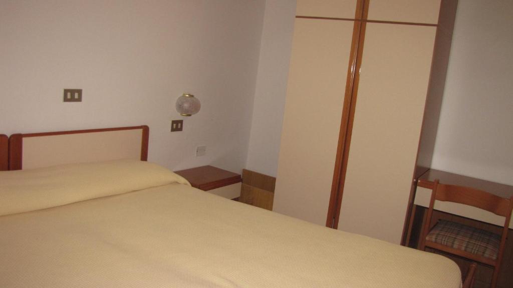 Postel nebo postele na pokoji v ubytování Albergo La Primula