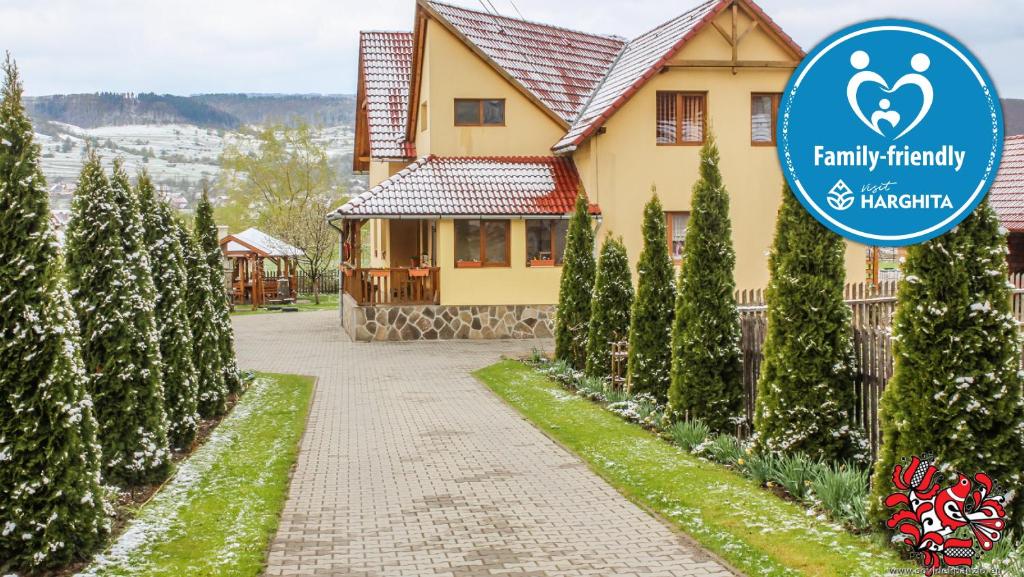 a house with a sign in front of it at Sóvidék Guesthouse in Praid