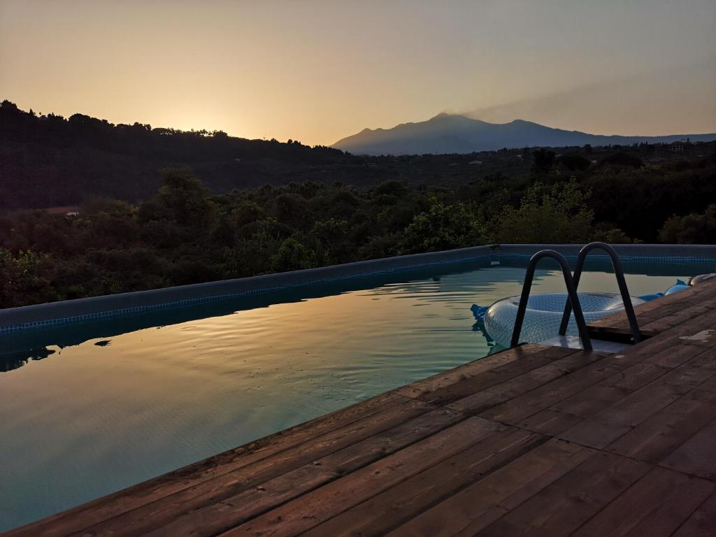 a swimming pool with a view of a mountain at Case Vacanze Fossanave in Santa Tecla