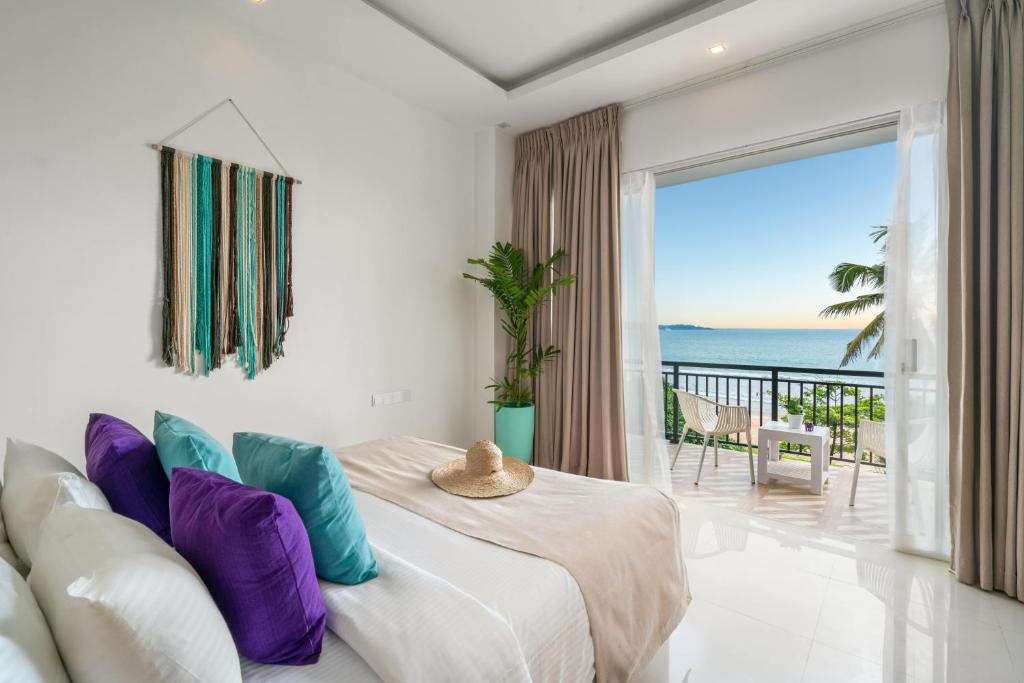 a bedroom with a bed and a view of the ocean at Outpost Weligama Beachfront in Weligama