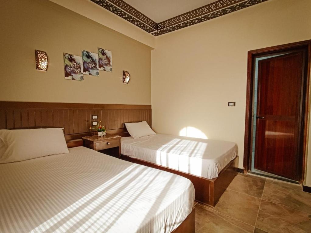 Postel nebo postele na pokoji v ubytování Shabana House