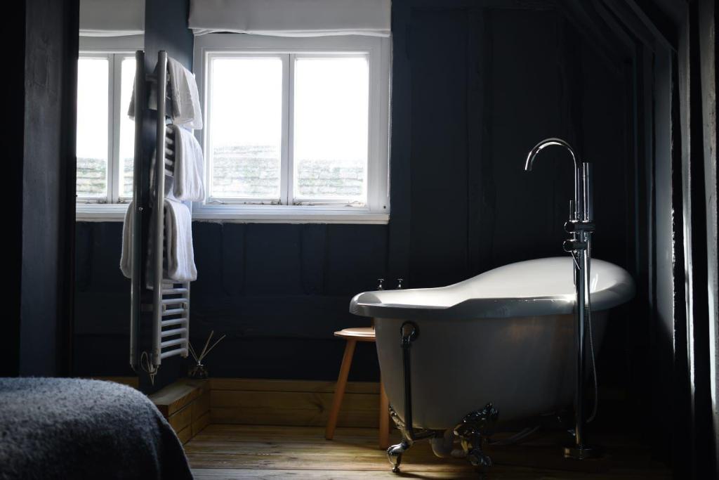 a bathroom with a bath tub and a window at Whitehouse Rye in Rye