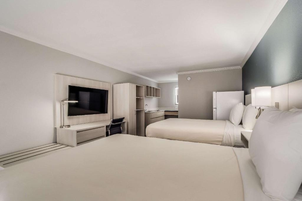 En eller flere senge i et værelse på MainStay Suites Florence