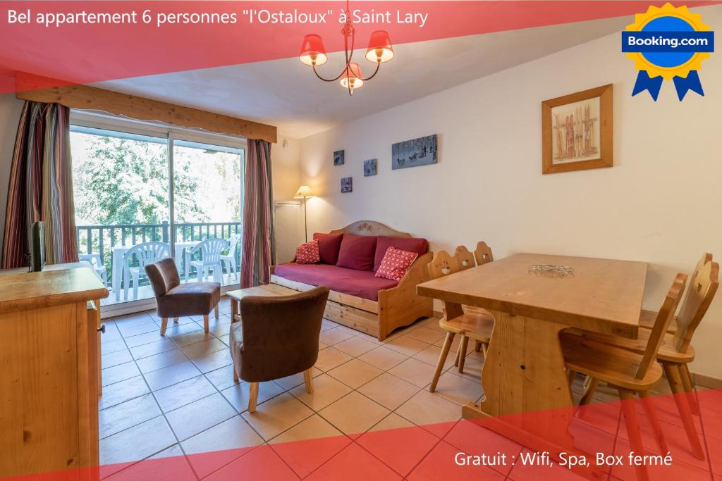 a living room with a table and a couch at Appartement "L'Ostaloux" 6 personnes - Saint Lary Soulan in Vielle-Aure