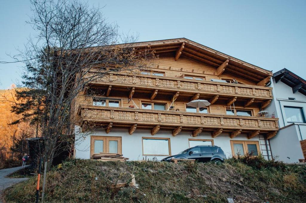 a house with a car parked in front of it at Appartement RUDI by MoniCare in Reith bei Seefeld