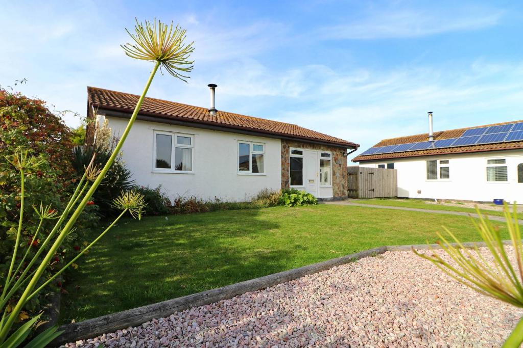 a house with solar panels on the roof at Holiday Bungalow, short drive to 7 Beaches! in St Merryn