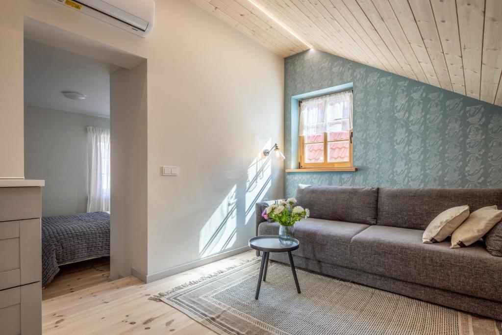 a living room with a couch and a window at B2 Apartments in Klaipėda