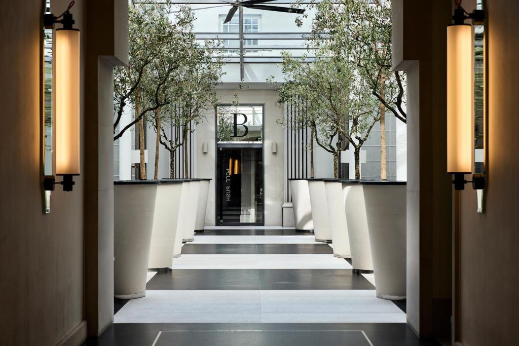 a hallway with trees on the sides of a building at H15 Boutique Hotel, Warsaw, a Member of Design Hotels in Warsaw