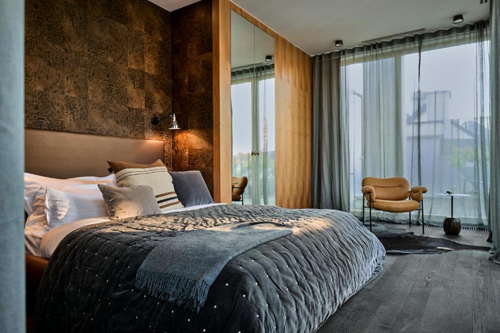 a bedroom with a large bed and a large window at H15 Boutique Hotel in Warsaw