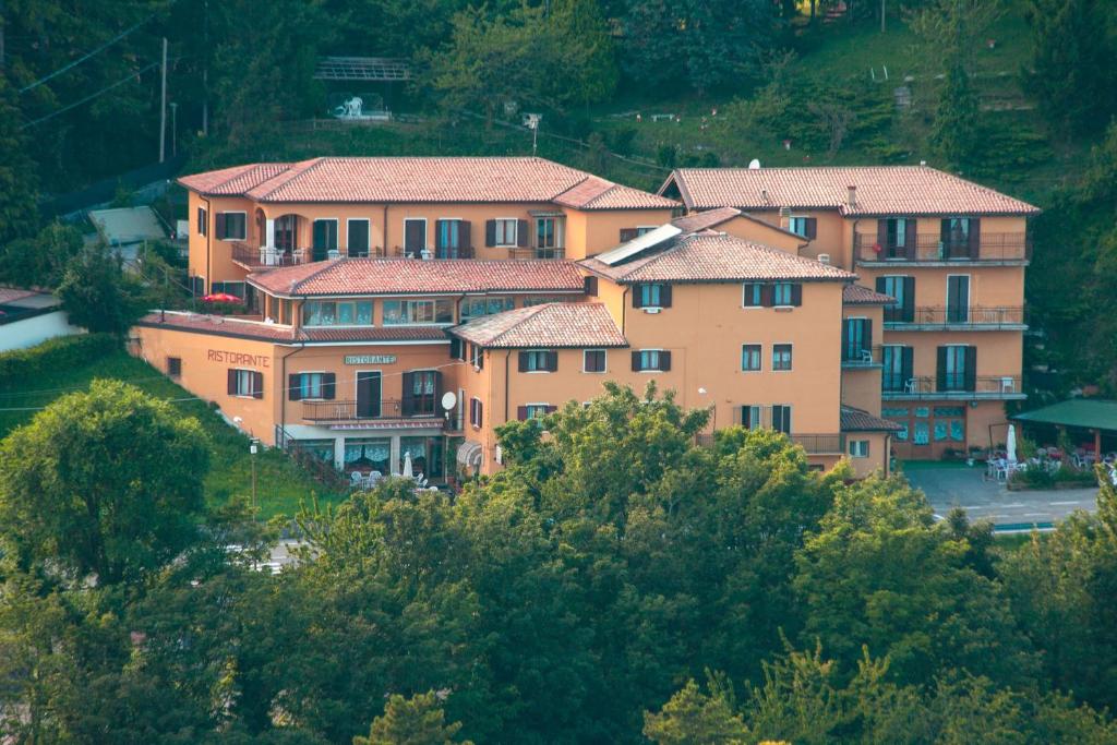 a group of buildings on top of a hill at Hotel Aurora in Spiazzi Di Caprino