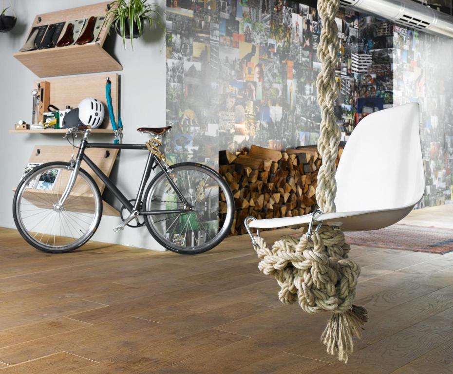 a bike parked in a room with a chair at 25hours Hotel Bikini Berlin in Berlin