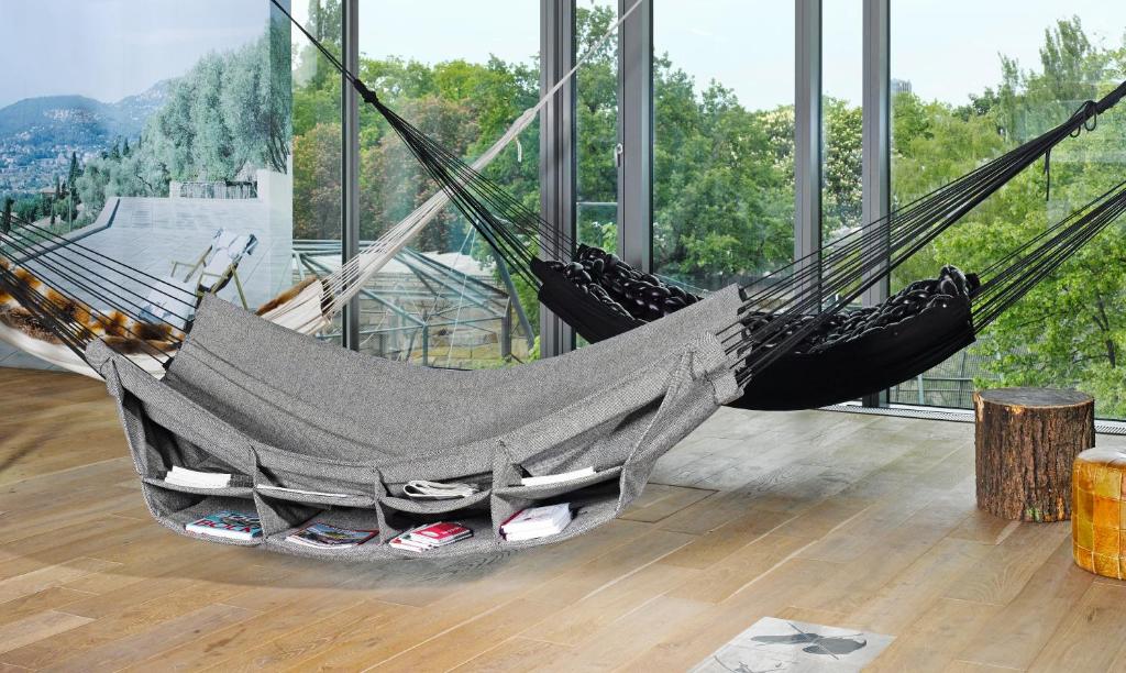 a hammock in a room with a large window at 25hours Hotel Bikini Berlin in Berlin