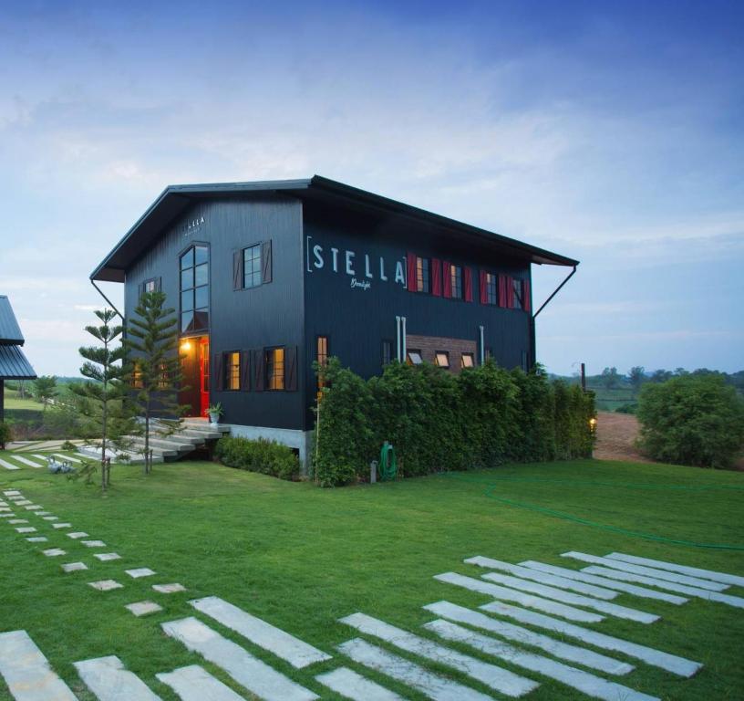 a black house with a sign on the front of it at Stella Moonlight Khaoyai in Pong Talong