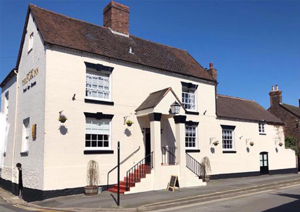 a white building on the side of a street at The Fox in Much Wenlock