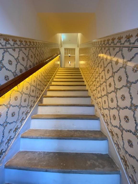 a staircase leading up to a building with lights at Casa Saudade luxury rooms in Faro