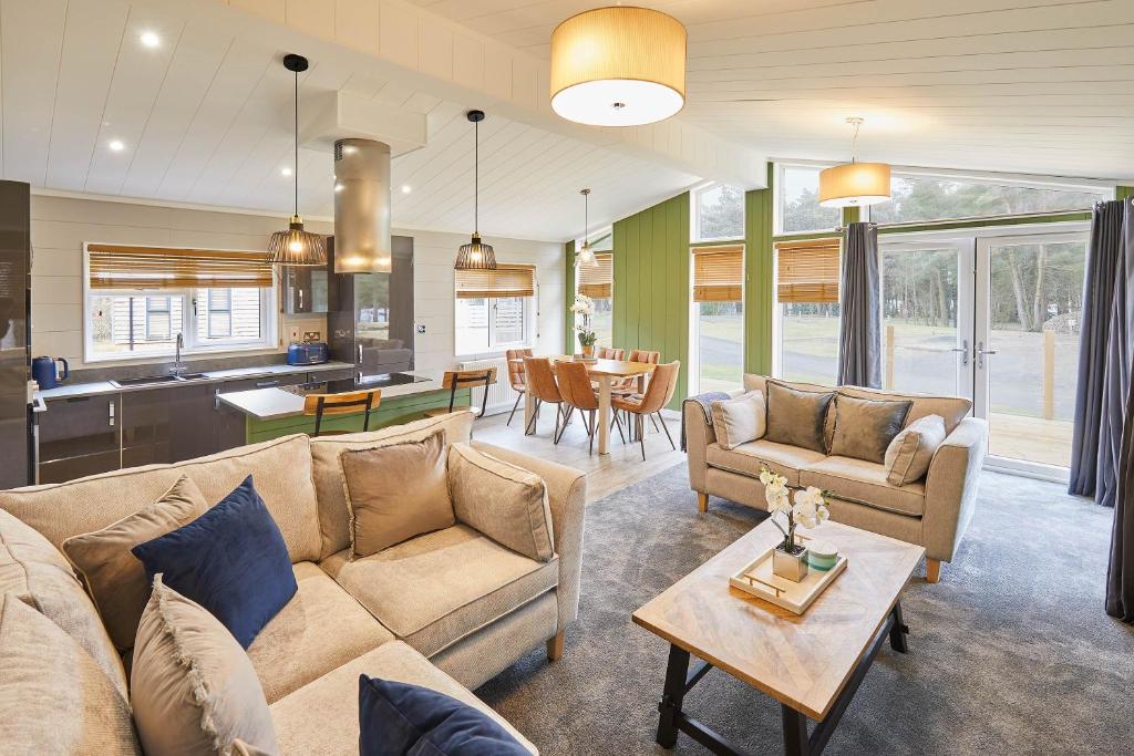 a living room with a couch and a table at Host & Stay - Eller Beck, The Cabin In The Woods in Egton