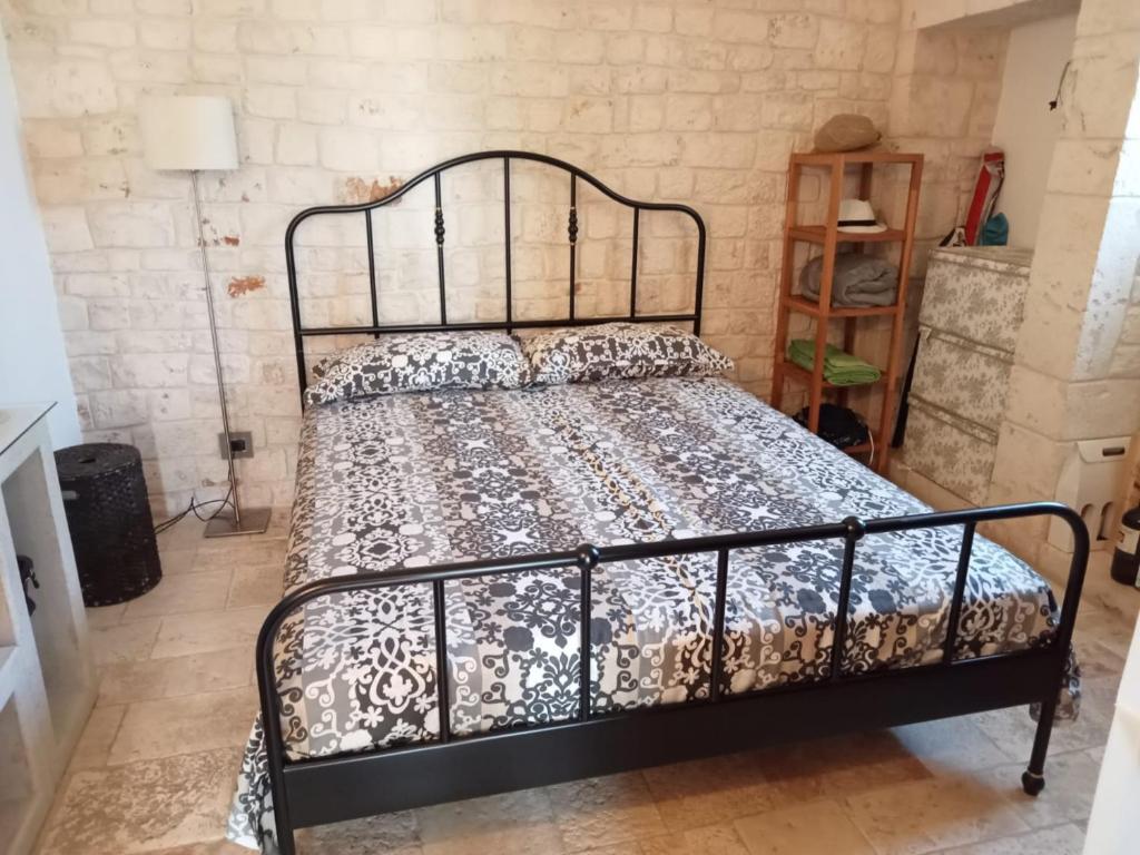 Postel nebo postele na pokoji v ubytování Masseria - Trulli Genius Loci Dimore
