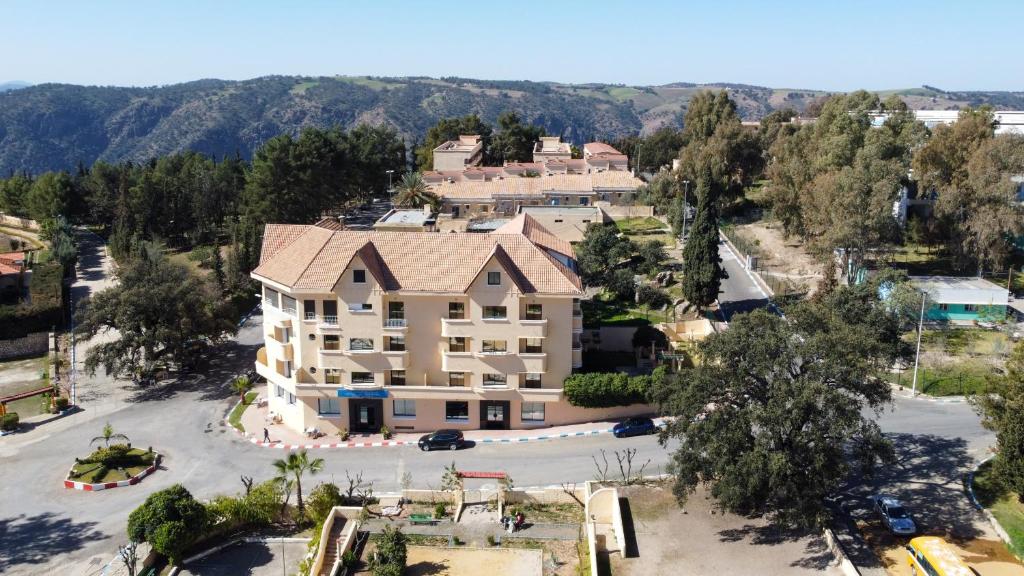 an aerial view of a large building with a parking lot at HOTEL DES THERMES in Tarmilet