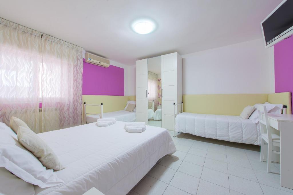 Postel nebo postele na pokoji v ubytování Hotel Galassia