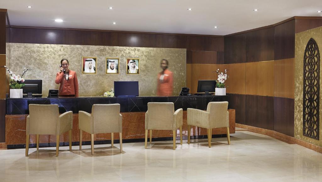 a man taking a picture of a hotel lobby at Gateway Hotel in Dubai
