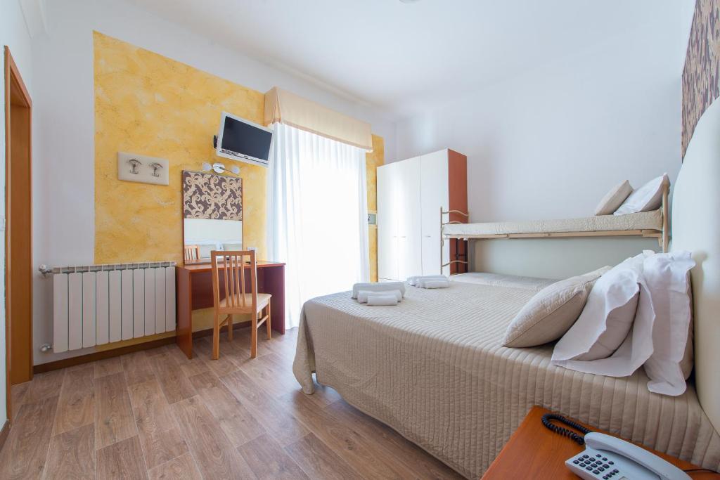 Postel nebo postele na pokoji v ubytování Hotel Galassia