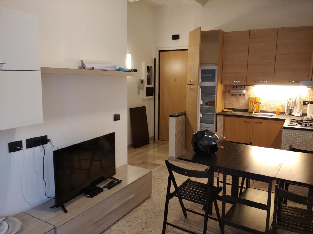 a kitchen and a living room with a table and a fireplace at Roma - Talenti in Rome