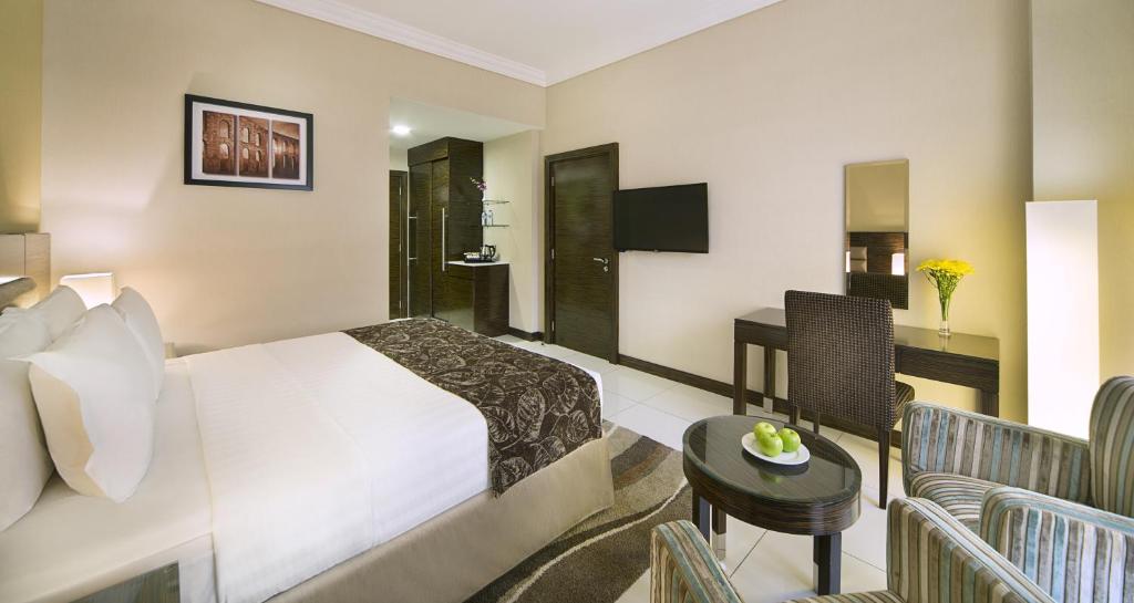 a hotel room with a bed and a bathroom at Gateway Hotel in Dubai