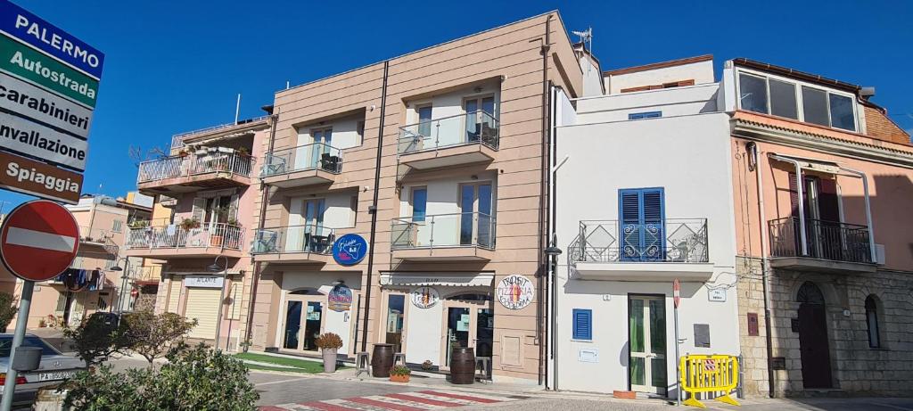 a building on the corner of a street at Belvedere Rent Rooms in Campofelice di Roccella