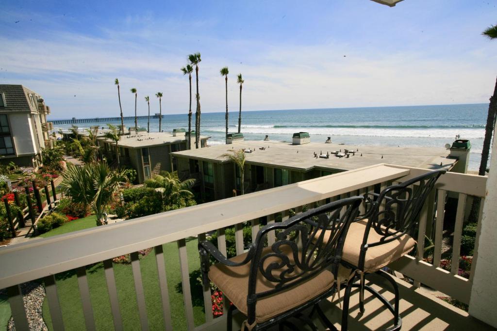 d'un balcon avec deux chaises et une vue sur la plage. dans l'établissement E210 - Starfish Studio, à Oceanside