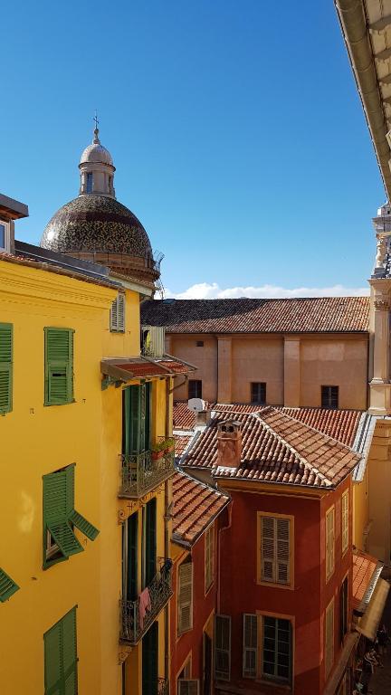 a view of the roofs of buildings in a city at Sunny apartment in heart of Nice Old Town in Nice
