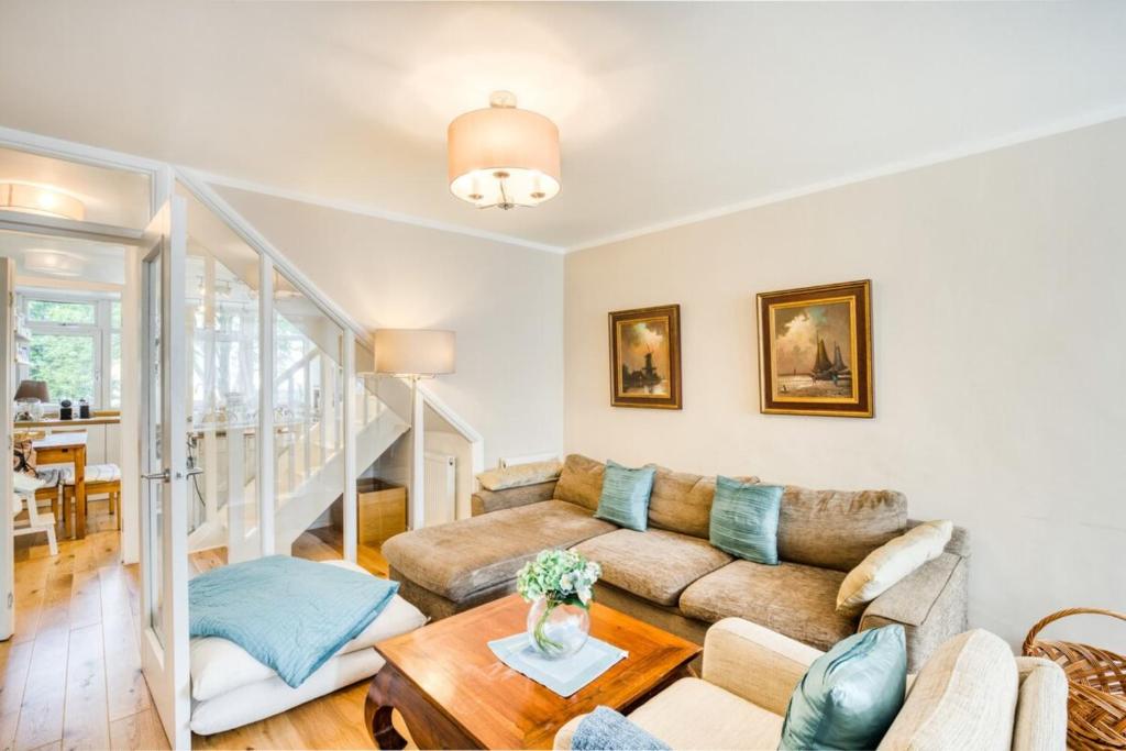 a living room with a couch and a table at Homely 4 Bedroom House in Brixton in London